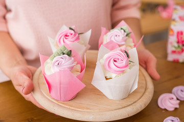 Close-up of beautiful cupcakes. Homemade cupcakes with cream and chocolate in a festive package