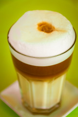 Milkshake or coffee served in a glass with lid