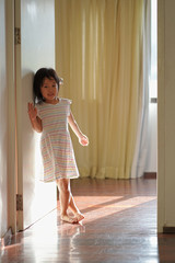 Asian chinese young child waking up and standing at the door