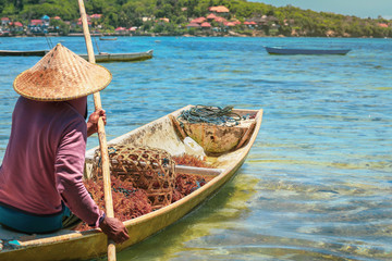 Selective focus on seaweed on fiherman wooden boat going to the sea