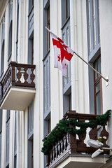 Flag of Georgia on the facade of the building. Fragment of the facade of the Embassy of Georgia in Minsk.