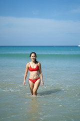 Asian Chinese Woman in various yoga poses at the beach