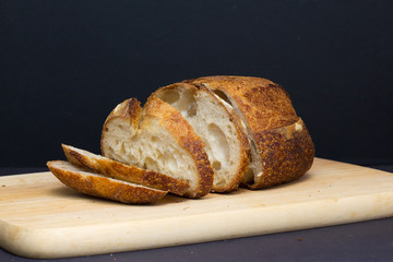 Slices of fresh sourdough on wood cutting board