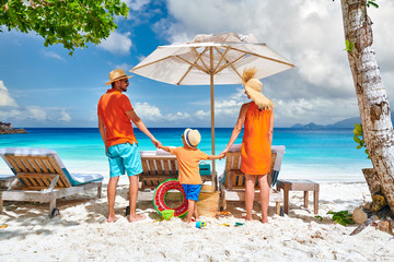 Family with three year old boy on beach. Seychelles, Mahe.