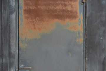 Rusty red on black iron door. Side of the door is black wood