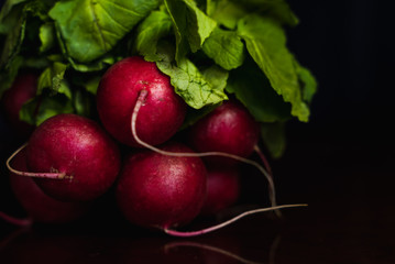 A bunch of radishes with a black background