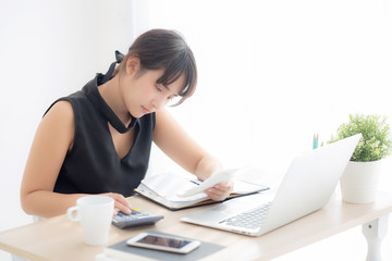 Beautiful young asian woman calculating expenses household and writing notebook on desk, girl checking bill and stress and note, female worry debt and tax, finance and business concept.