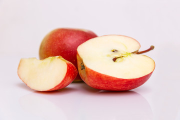 Group of juicy red apples on a white background .. Healthy diet and vegan food. Close-up.