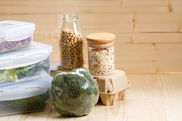 boxes with raw vegetables for stock up food on wooden background