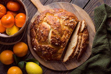 Freshly baked sweet braided bread loaf with fruit fillings and almond slices
