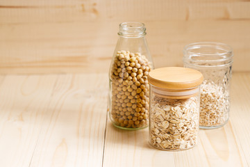 bottles with dried food for stock up food on wooden background