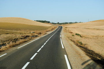 Asphalt road through the countryside in summer day, Morocco.