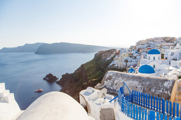 Famous blue dome churches in Oia, (Santorini, Greece) in the morning. White architecture of Oia...
