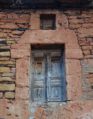 Fototapeta na wymiar Traditional facade of stone and wood windows in the village of Albendiego. Guadalajara. Spain. 