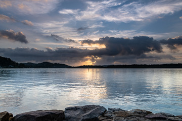 Fototapeta na wymiar Clouds and Sunrise over the Bay