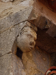 Detail of cornice with bracket of head of african man. Medieval Romanesque Church of Campisabalos....