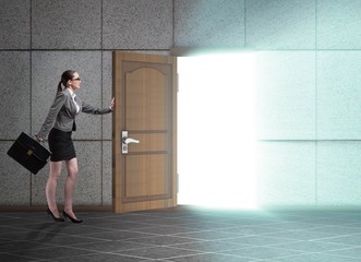 Fototapeta na wymiar Businesswoman walking towards open door