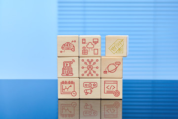 The concept of search engine optimization SEO. On wooden cubes on a blue background, the cubes have icons with the image and inscription of various actions and events. Free space for text.
