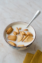 Baby Biscuits with Milk in Bowl also for Theeting.