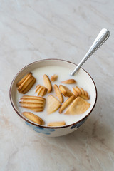 Baby Biscuits with Milk in Bowl also for Theeting.