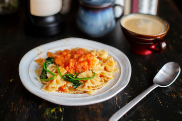 Homemade farfalle, with spinach and tomato sauce