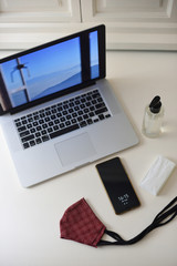 .Telecommuting at home, face mask and laptop.