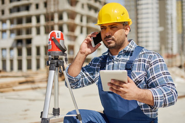 An engineers uses measuring equipment at his work place.