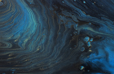 art photography of abstract marbleized effect background. Gold, black and blue creative colors....