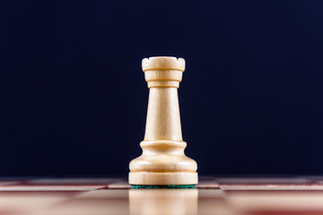 white chess rook on a black background