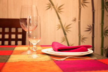 minimalist table set service for one person on multicolored tablecloth