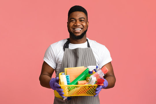 Portrait Of Positive Black Man Holding Basket With Cleaning Tools