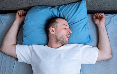 Man Sleeping And Snoring Lying In Bed At Home, Above-View