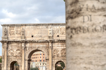Arch of Constantine or Arco di Costantino and part of Colosseum to right. High Roman structure, triumphal arch, victory over Maxentius at Battle of Milvian Bridge, made up of three decorated arches.