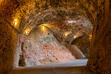 The stone walls of the casemates in an ancient fortress in Savona, Italy