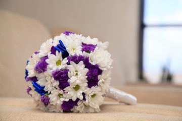 Bridal bouquet lies on a cloth surface