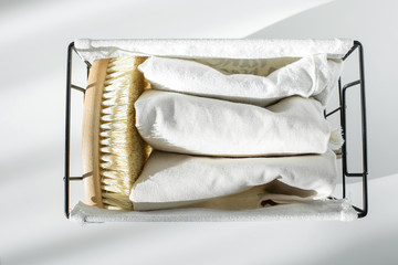 Eco natural body brush and cotton towels in metal basket. Zero waste concept. Plastic free. Copy space