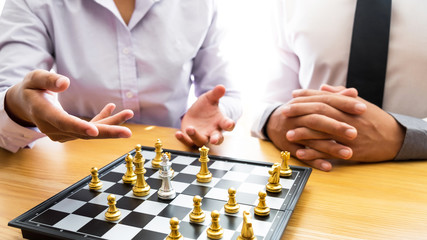 Two business man are planning strategy of business on board game.