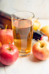 Apple juice with freshly harvested apples on the rustic background. Selective focus. Shallow depth of field.