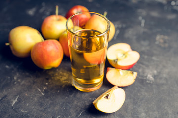 Apple juice with freshly harvested apples on the rustic background. Selective focus. Shallow depth of field.