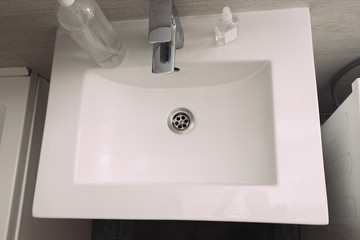 white sink in the bathroom, pandemic hand disinfection, carpet 19, disinfectant, soap and tap