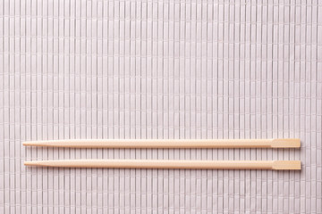 Wooden chopsticks close-up. Two chopsticks on the table.