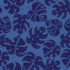 Fototapeta na wymiar Blue silhouettes of tropical leaves seamless pattern