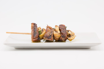 grilled meat brochette with mushrooms