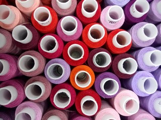  multicolored thread on bobbins close up