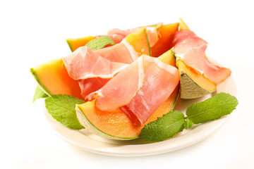melon slice with prosciutto ham and basil