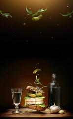 A sandwich in Ukrainian style with slice of bacon on brown background with flying ingredients...