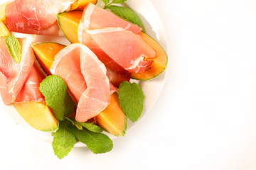 melon slice with prosciutto ham and basil