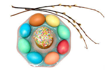 Easter colored eggs and Easter cake on a plate top view isolated on white background