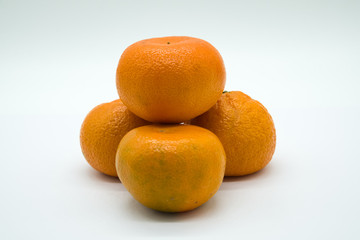 Four Satsuma Oranges on a White background.