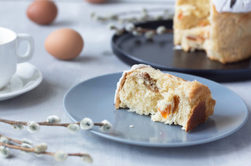 slice of sweet bread with white icing, dried apricots and nuts on a plate, baking, Easter cake, easter